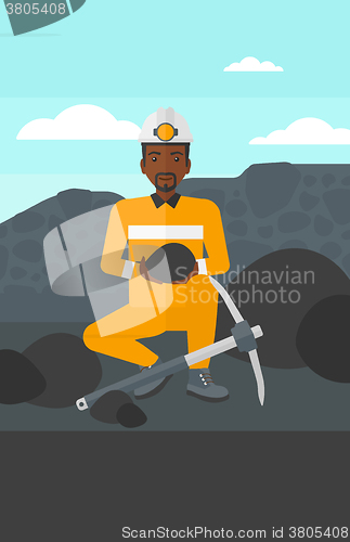 Image of Miner holding coal in hands.