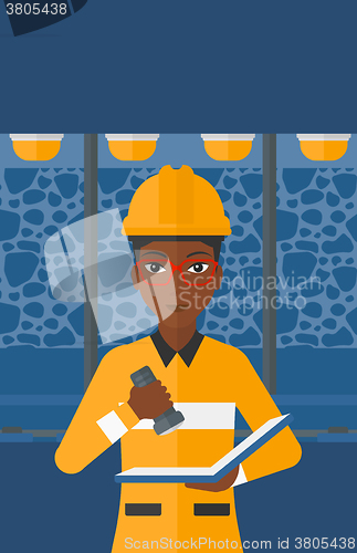 Image of Miner checking documents.