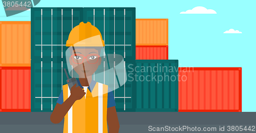 Image of Stevedore standing on cargo containers background.