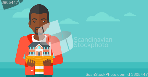 Image of Man holding house model.