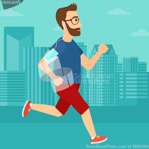 Image of Man jogging with earphones and smartphone.