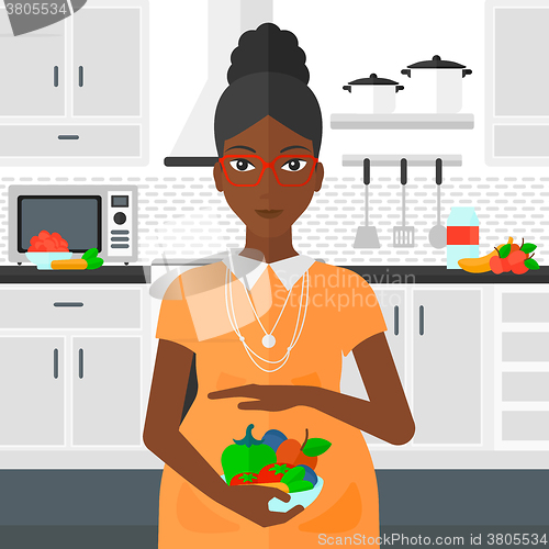 Image of Pregnant woman with vegetables.