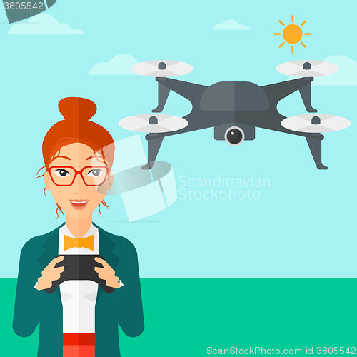 Image of Woman flying drone.