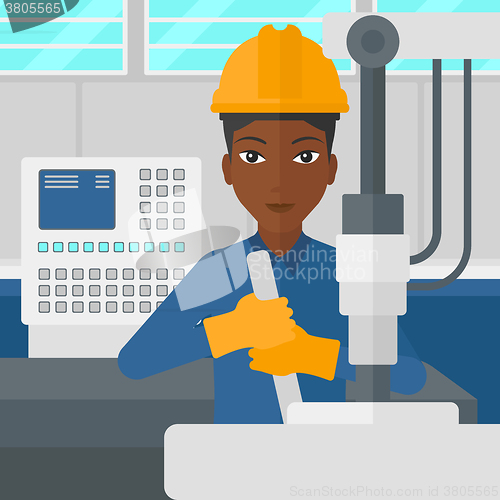 Image of Woman working with industrial equipment.