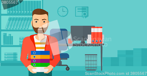 Image of Man holding pile of folders.