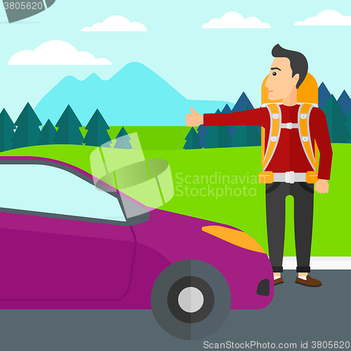 Image of Young man hitchhiking.