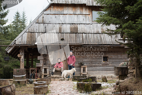 Image of frineds together in front of old wooden house