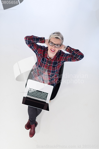 Image of top view of young business woman working on laptop computer