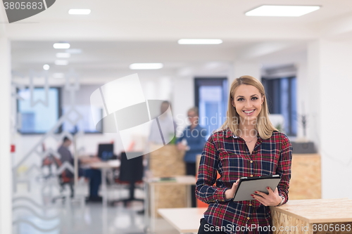 Image of portrait of young business woman at office with team in backgrou