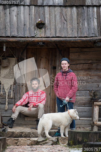 Image of frineds together in front of old wooden house