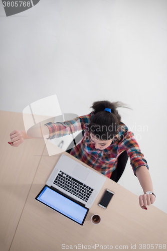 Image of top view of young business woman working on laptop