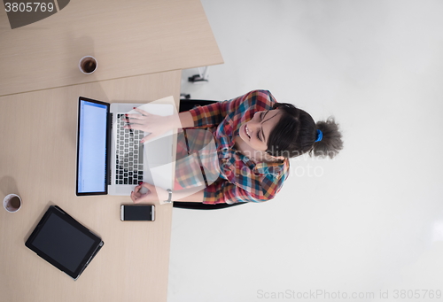 Image of top view of young business woman working on laptop