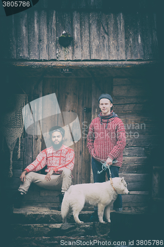 Image of frineds together in front of old wooden house