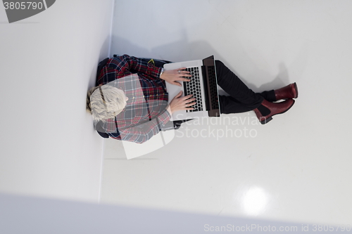 Image of top view of young business woman working on laptop computer