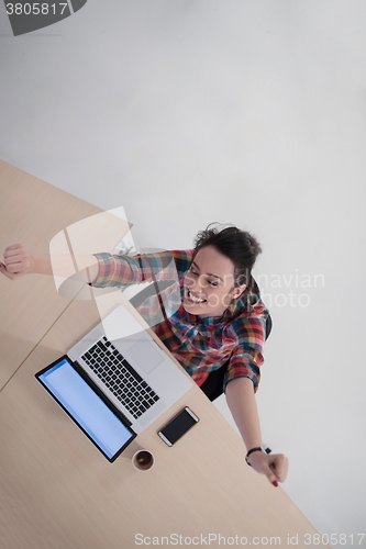 Image of top view of young business woman working on laptop