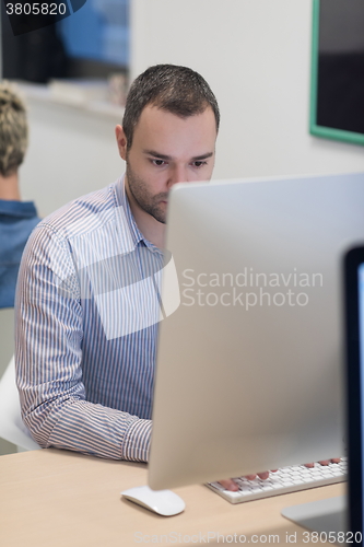 Image of startup business, software developer working on desktop computer