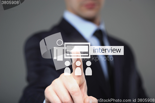Image of business, technology and internet concept - businessman pressing interview button on virtual screens