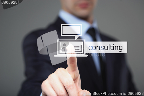 Image of business, technology, internet and networking concept - businessman pressing consulting button on virtual screens