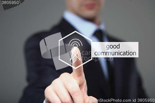 Image of businessman pressing a touchscreen communication button. 