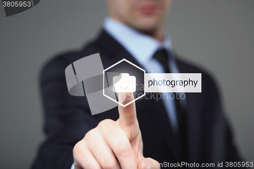 Image of Close up of businessman touching camera icon on media screen