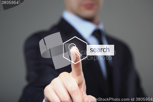 Image of technology and internet concept - businessman pressing SEARCH button on virtual screens