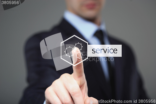 Image of technology and internet concept - businessman pressing service button on virtual screens