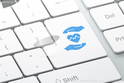 Image of Insurance concept: Heart And Palm on computer keyboard background