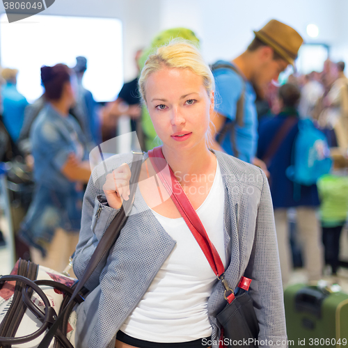 Image of Female traveller waiting in airport terminal.