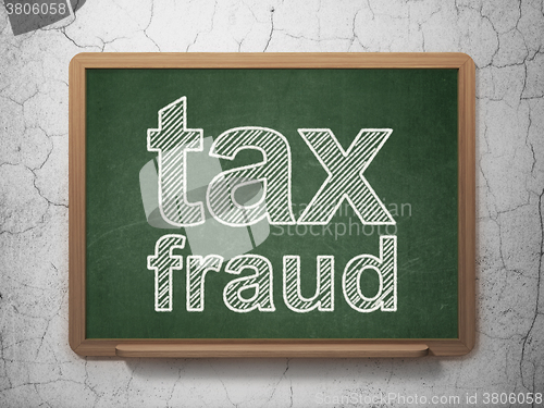 Image of Law concept: Tax Fraud on chalkboard background