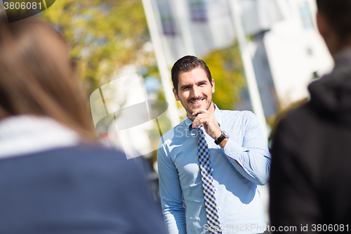 Image of Informal out of office outdoors business meeting.