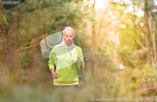 Image of Pretty young girl runner in the forest. 