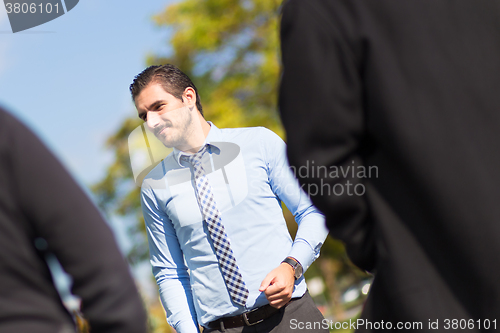 Image of Informal out of office outdoors business meeting.