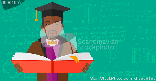 Image of Man in graduation cap holding book.