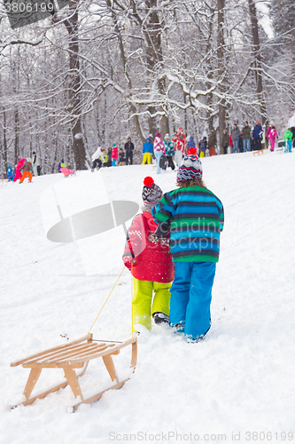 Image of Winter fun, snow, children sledding at winter time.