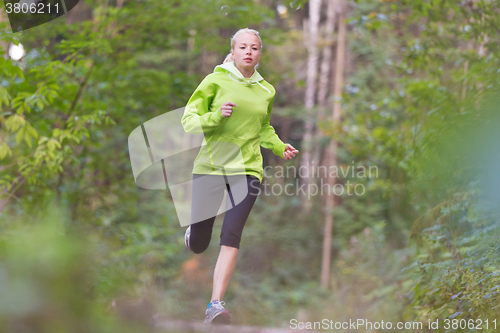 Image of Pretty young girl runner in the forest. 
