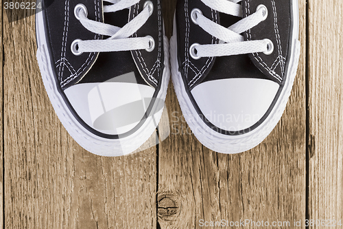 Image of black sneakers on black background