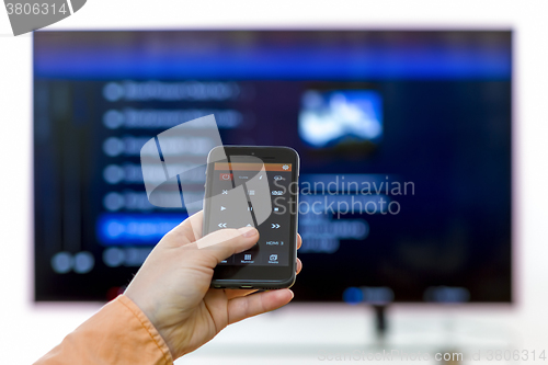 Image of Closeup on woman hand holding smartphone and use a app with remo