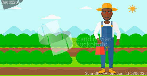 Image of Farmer with watering can.