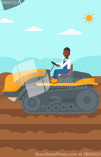 Image of Farmer driving catepillar tractor.