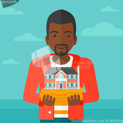 Image of Man holding house model.