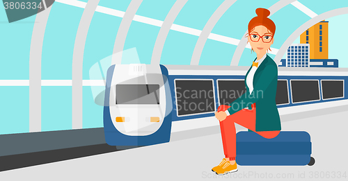 Image of Woman sitting on railway platform.