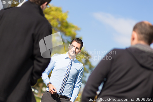 Image of Businessman being blackmailed by two racketeers.