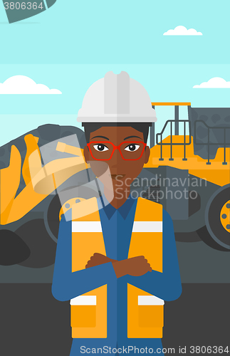 Image of Miner with mining equipment on background.