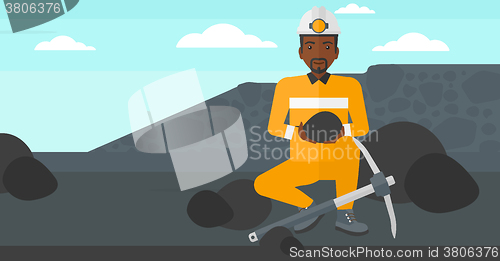 Image of Miner holding coal in hands.