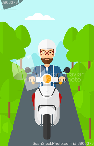 Image of Man riding scooter.