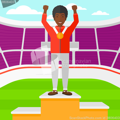 Image of Athlete with medal and hands raised.