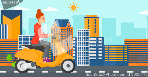 Image of Woman riding scooter.