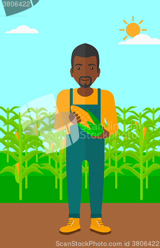 Image of Farmer holding corn.