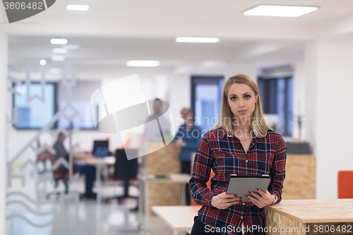 Image of portrait of young business woman at office with team in backgrou