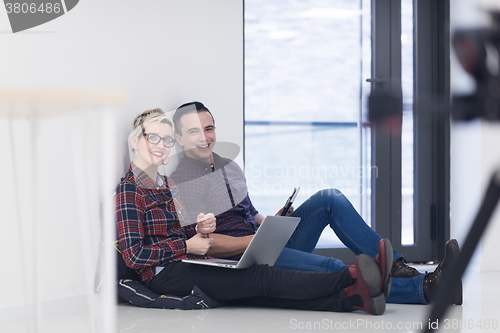 Image of startup business, couple working on laptop computer at office